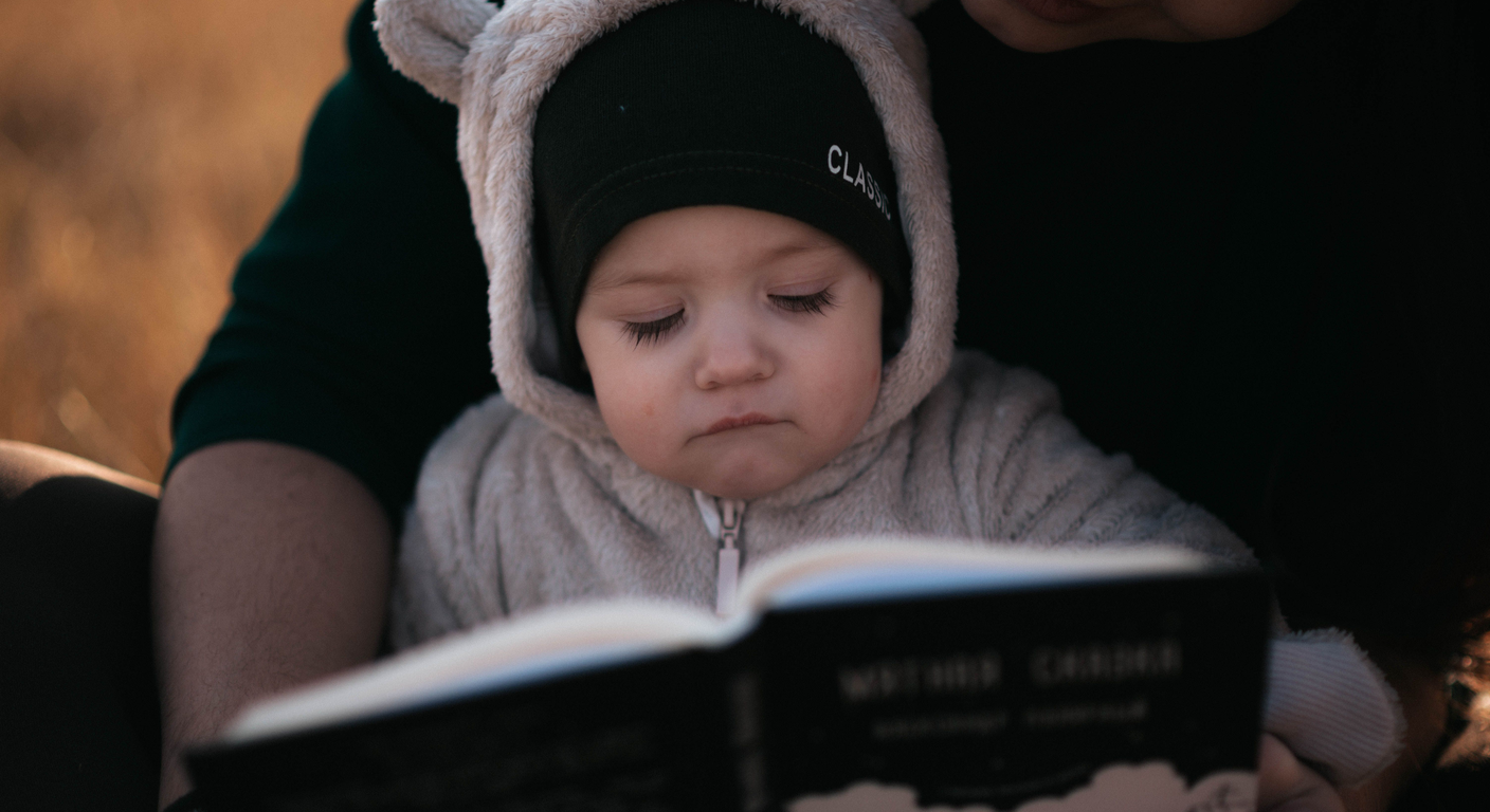 Mother and toddler sharing a quiet moment with a bilingual picture book in soft natural light