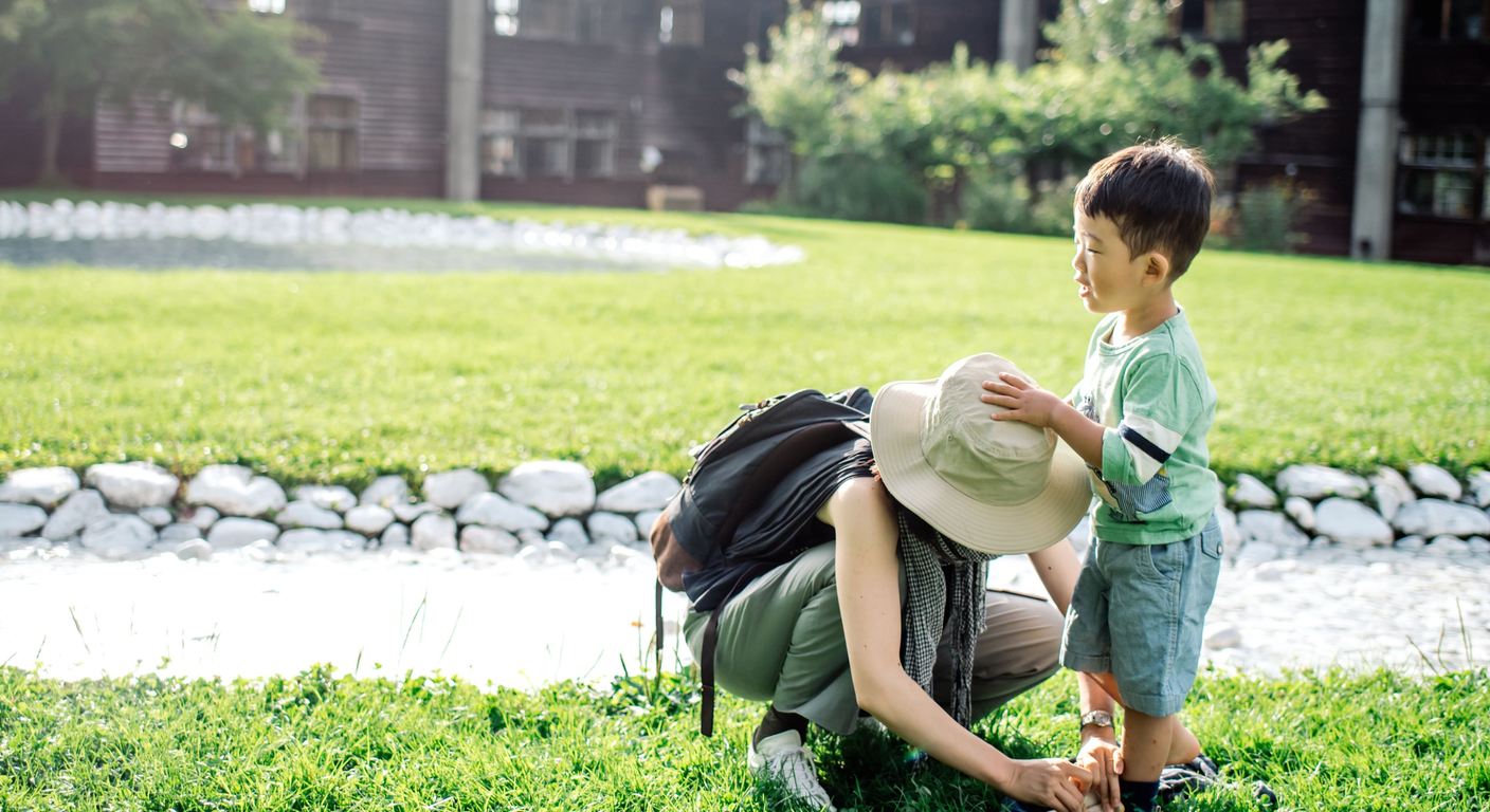Mother and child playing together outdoors in a park, enjoying quality time.