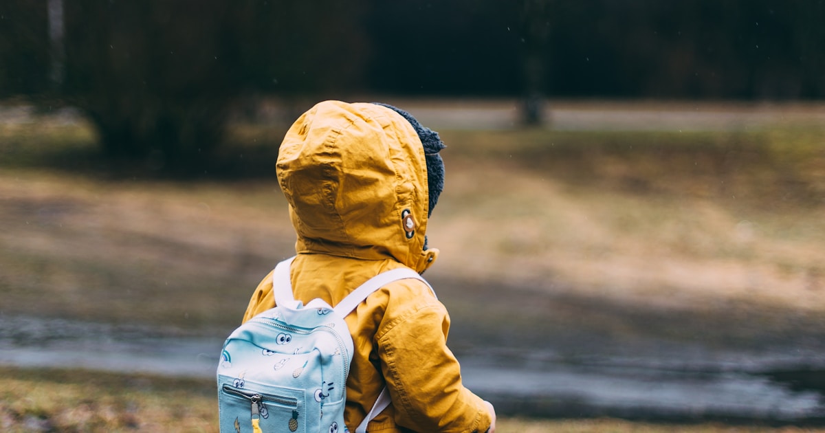 shallow focus photo of toddler walking near river