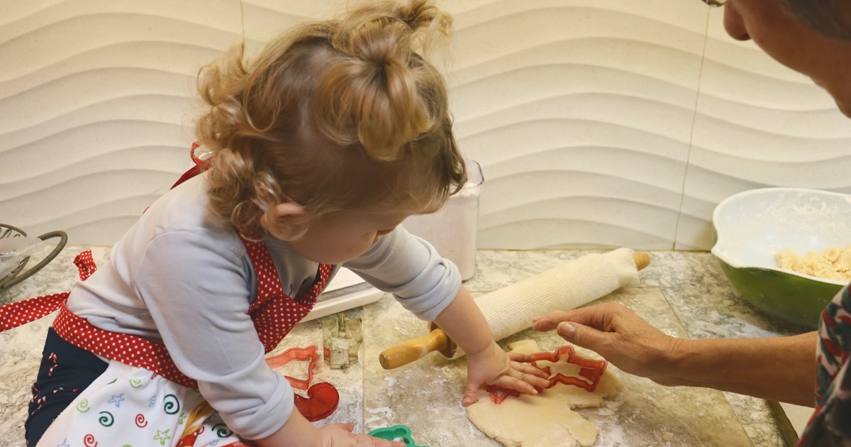 a woman and a little girl making dough